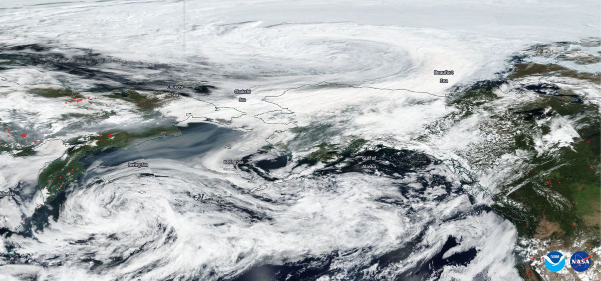 Satellite image of Siberia and Alaska with visible smoke and clouds
