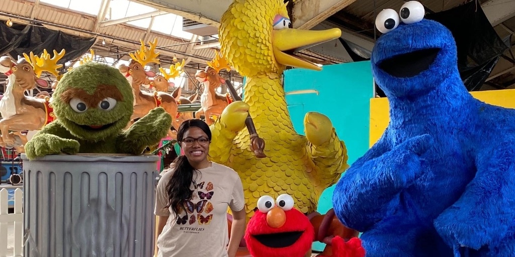 ParadeCo's tweet photo. It's #NationalInternDay, and we are celebrating our fabulous Events Intern, Melaney! 
Melaney recently graduated from @WesternMichU. Her favorite thing about The Parade Company is all of the floats and Big Heads are created right in the studio. #DetroitParade https://t.co/pYPOhJ7QAE