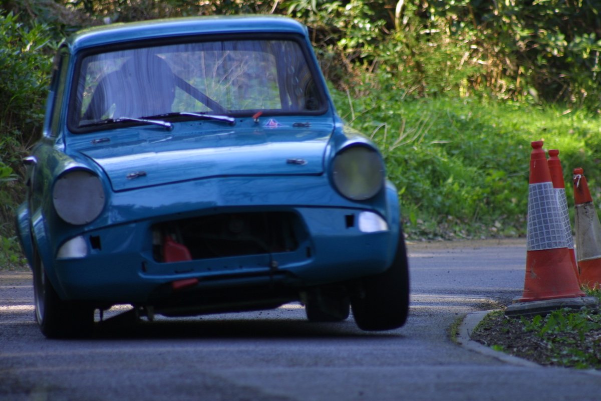 Speed_Hillclimb's tweet photo. Hillclimb History: Nick Tremlett lifts a wheel with his highly-modified Ford Anglia 105E during his usual all-action-attack on The Esses @WiscombeP during the @ASWMC meeting in April 2004. #Hillclimb #Speed #Racing #Motorsport #AngleBox https://t.co/0XymgbTj6X