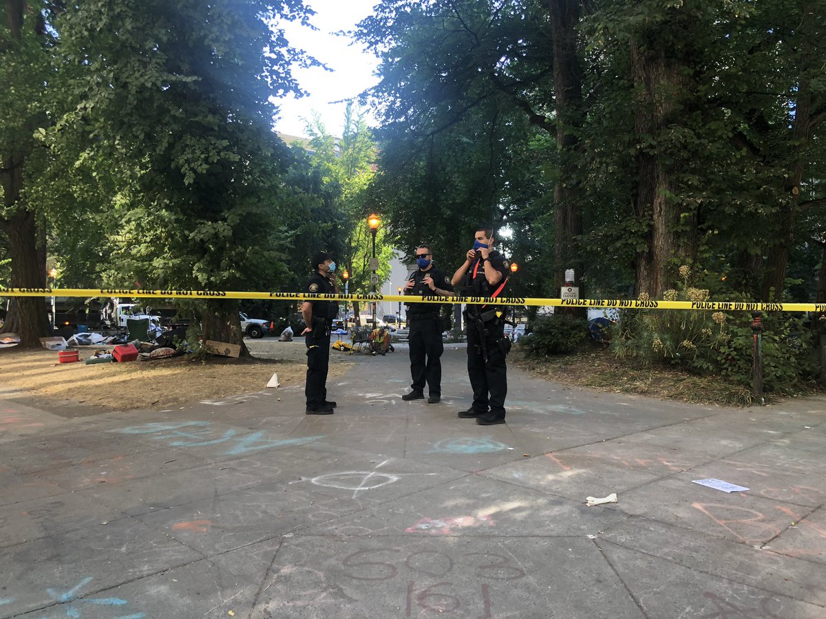 Lonwsdale and Chapman squares being cleared at the request of Oregon State Police. Groups of Portland Police officers are stationed at every corner around Chapman Square.