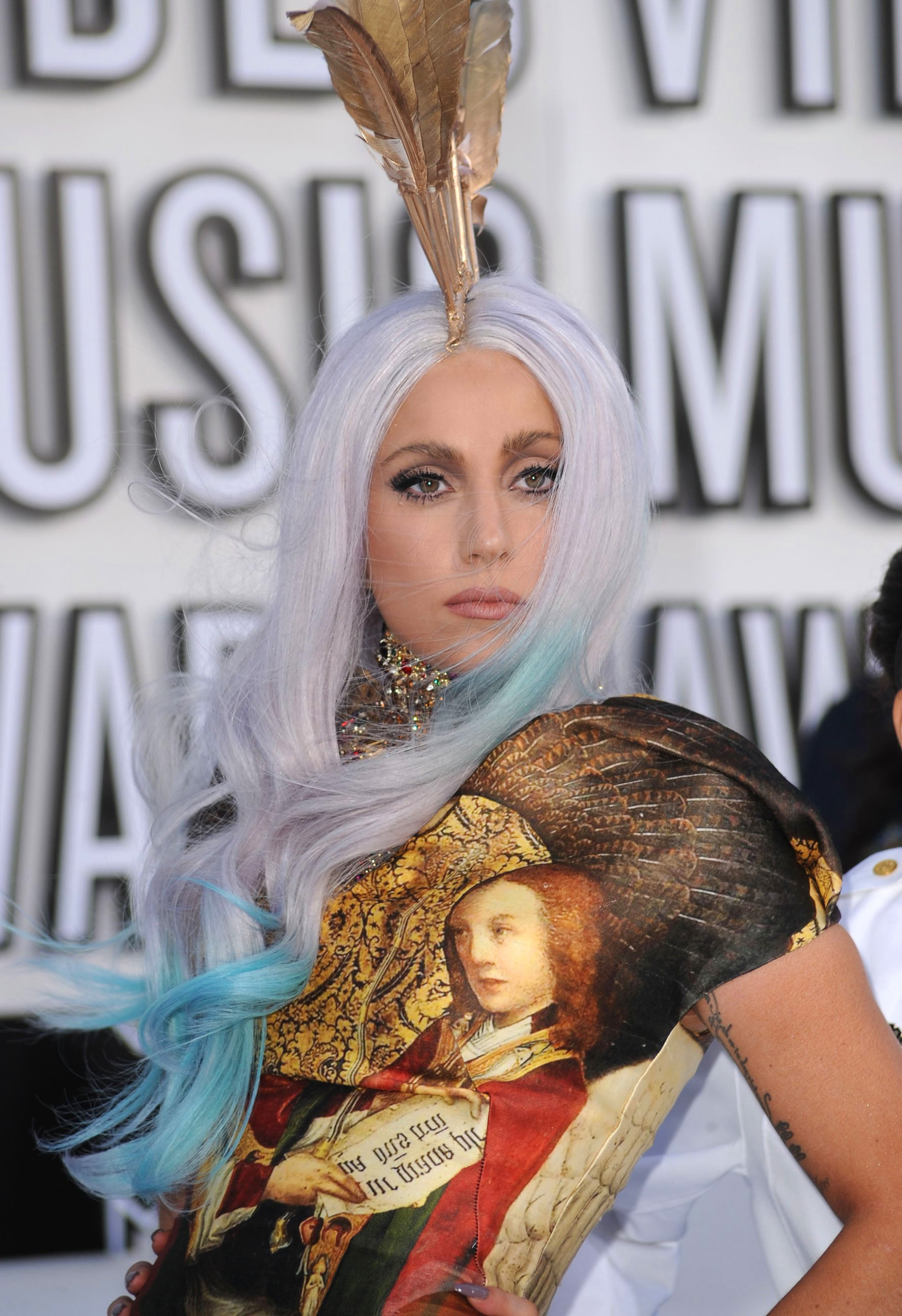 Gaga Daily on X Throwback Lady Gaga brings gay discharged soldiers to the 2010 VMAs red carpet to raise awareness around DADT. Custom dress and heels by Alexander McQueen. https t OosNM7ENG3 X