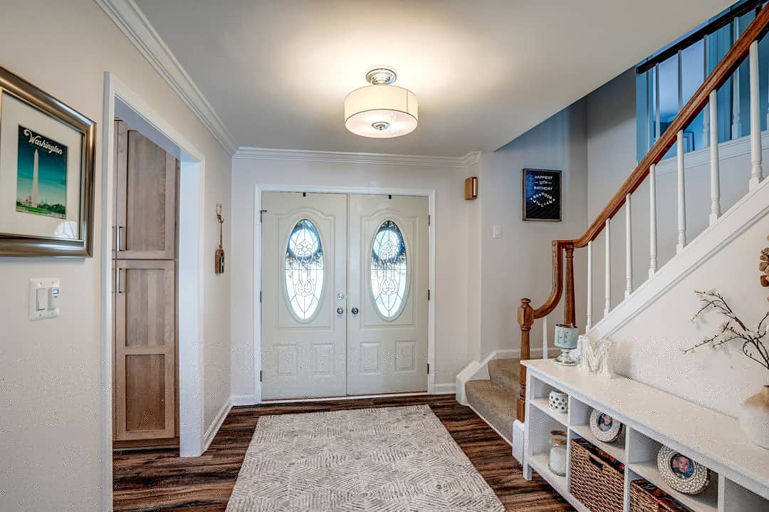 What a lovely, inviting space! You'll feel like family when you walk into this home. #entryway #entrywaydecor #entrywaytable #entrywaydesign #entrywaygoals #entrywayinspo #entrywayinspiration #entrywaylighting #entrywaymakeover #home #homedesign #designbuild #homereno #remodel
