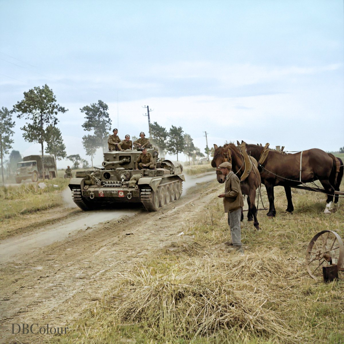 Cromwell tanks of 7th Armoured Division pass a French Farmer and his horses, while moving up at the start of Operation 'Bluecoat', the British offensive south-east of Caumont, Calvados.  30 July 1944.  © IWM B 8183