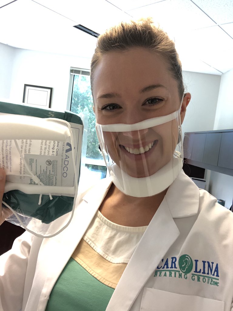 CarolinaHear's tweet photo. We all use visual cues to help us communicate. Face coverings, though necessary, make it especially difficult. We call it mask-induced hearing loss. 😷 Dr. Beeg is visiting area physicians’ offices to help out by giving them a clear face mask.👂🏼 https://t.co/jCLKsP0JFp