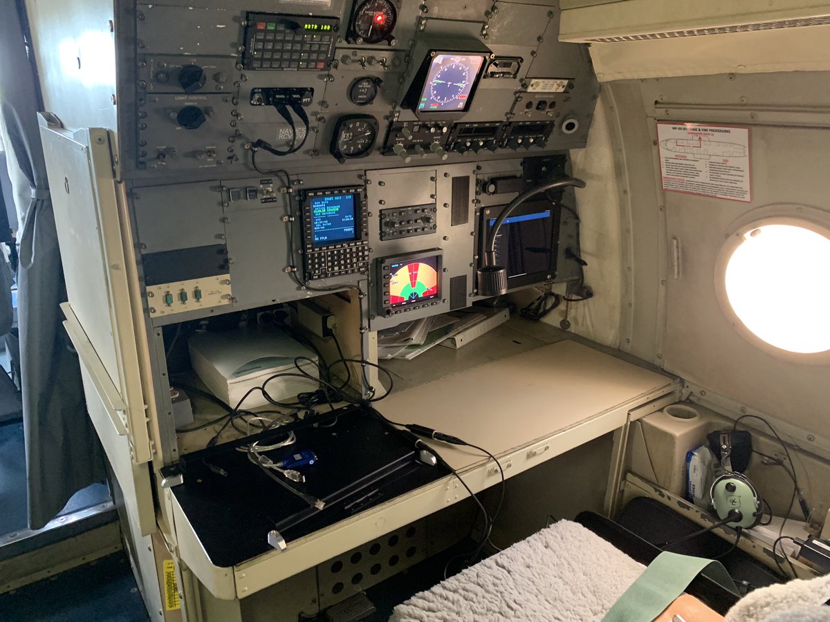 Across from them is our navigator, who helps communicate on the radios and helps the flight director determine best tracks through the storm.
