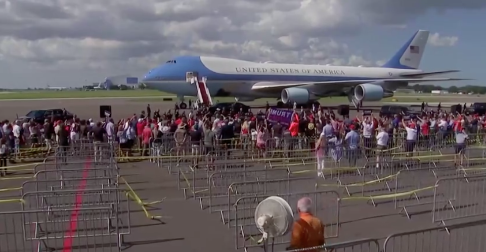 nowthisimpact's tweet image. A wider shot shows more Trump supporters bunched at the front of empty rows of guard rails