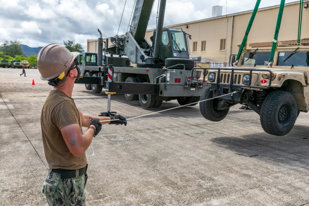 USPACOM's tweet photo. Seabees assigned to Naval Mobile Construction Battalion #NMCB1 in Guam perform turnover lifts with a Humvee as part of the battalion evaluation equipment program #BEEP demonstrating the crane is in proper working order. #ForgedByTheSeabees #FreeandOpenIndoPacific. https://t.co/O35ha0oisc