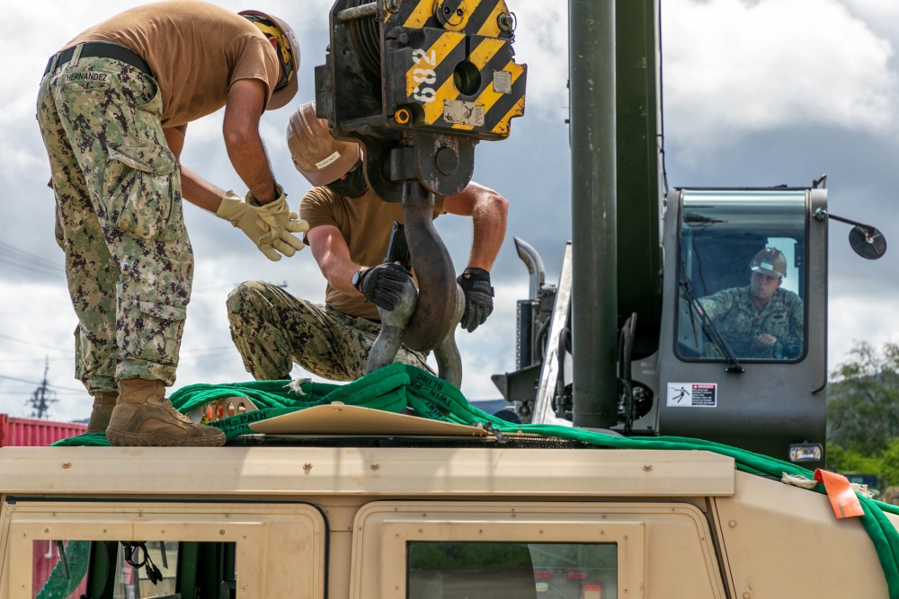 USPACOM's tweet photo. Seabees assigned to Naval Mobile Construction Battalion #NMCB1 in Guam perform turnover lifts with a Humvee as part of the battalion evaluation equipment program #BEEP demonstrating the crane is in proper working order. #ForgedByTheSeabees #FreeandOpenIndoPacific. https://t.co/O35ha0oisc