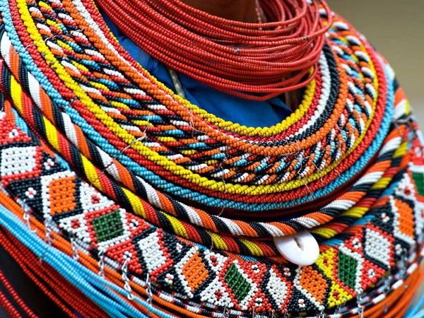 Nala (who is played by South African artist Nandi Madida) is readied by her bridesmaids while they wear jewelry and hairstyles inspired by the Maasai of Eastern Africa.