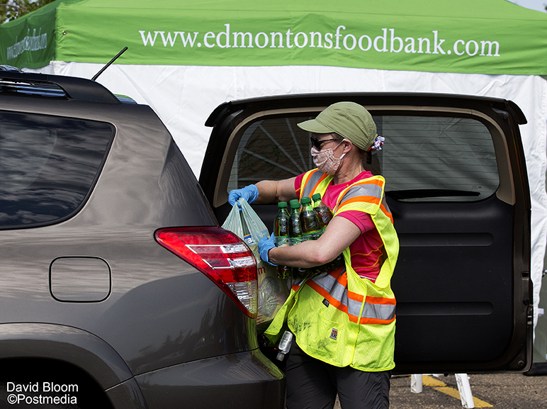 Volunteers unload donations during the <a href="/yegfoodbank/">Edmonton's Food Bank</a> drive thru Heritage Food Drive at Southgate Centre mall. Traditionally the food bank would be collecting donations at the Heritage Fest this weekend. Donations are being accepted until 4 p.m. #yeg