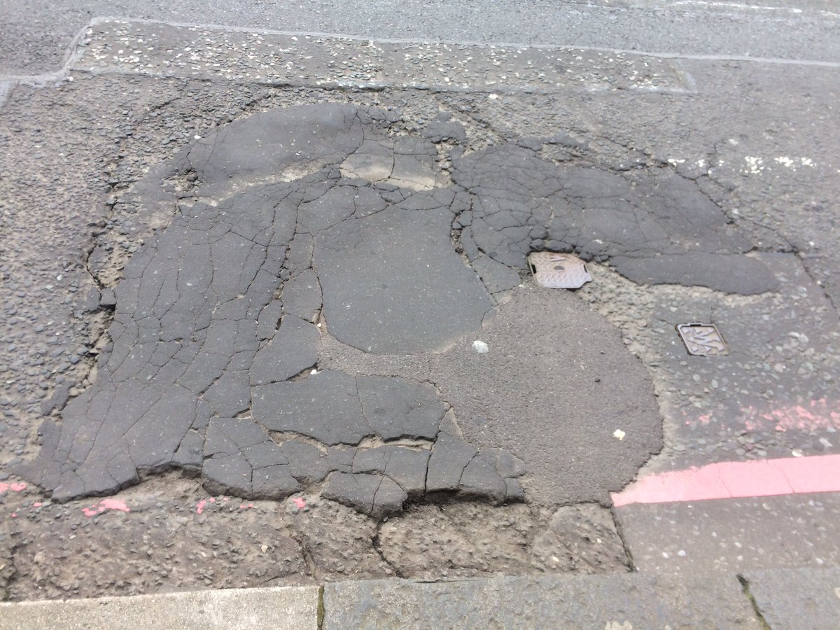 Some fun road surfaces pics! (At a bus stop). Another fine reason to take the lane.