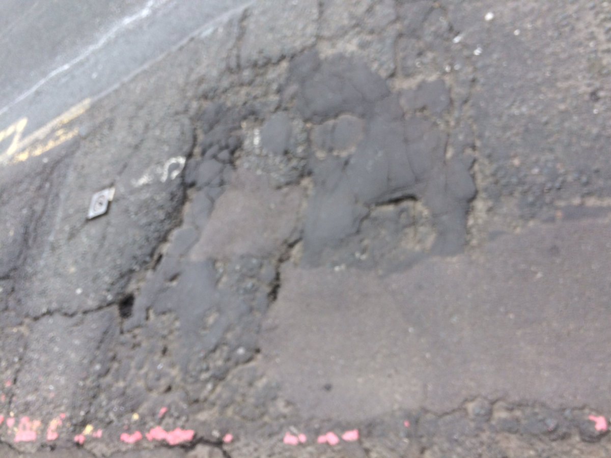 Some fun road surfaces pics! (At a bus stop). Another fine reason to take the lane.