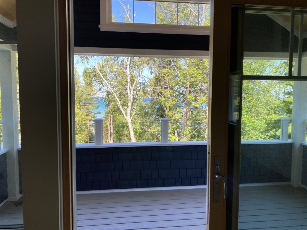 New second floor master bedroom covered porch with a lake view #Chba #netzero #cottage