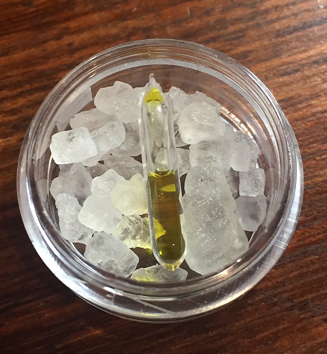 Chlorine  #elementphotos. Chlorine becomes a yellow liquid under high pressure; here a high-pressure ampoule lies on a bed of rocksalt (NaCl).