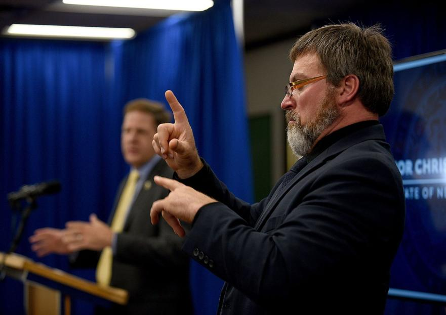 UnionLeader's tweet photo. In the low-ceilinged room in Concord where the governor briefs the media, interpreter David Krueger, dressed in dark clothes to not distract from his hands, stands to the side and signs the latest on the pandemic for the deaf.
https://t.co/loOmKZ43d9 https://t.co/tBSIBz1a3N