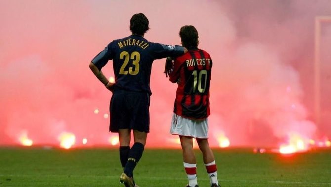 Marco Materazzi and Rui Costa look on as the San Siro turf is bombarded with missiles during the Milan derby in 2005. 🔥