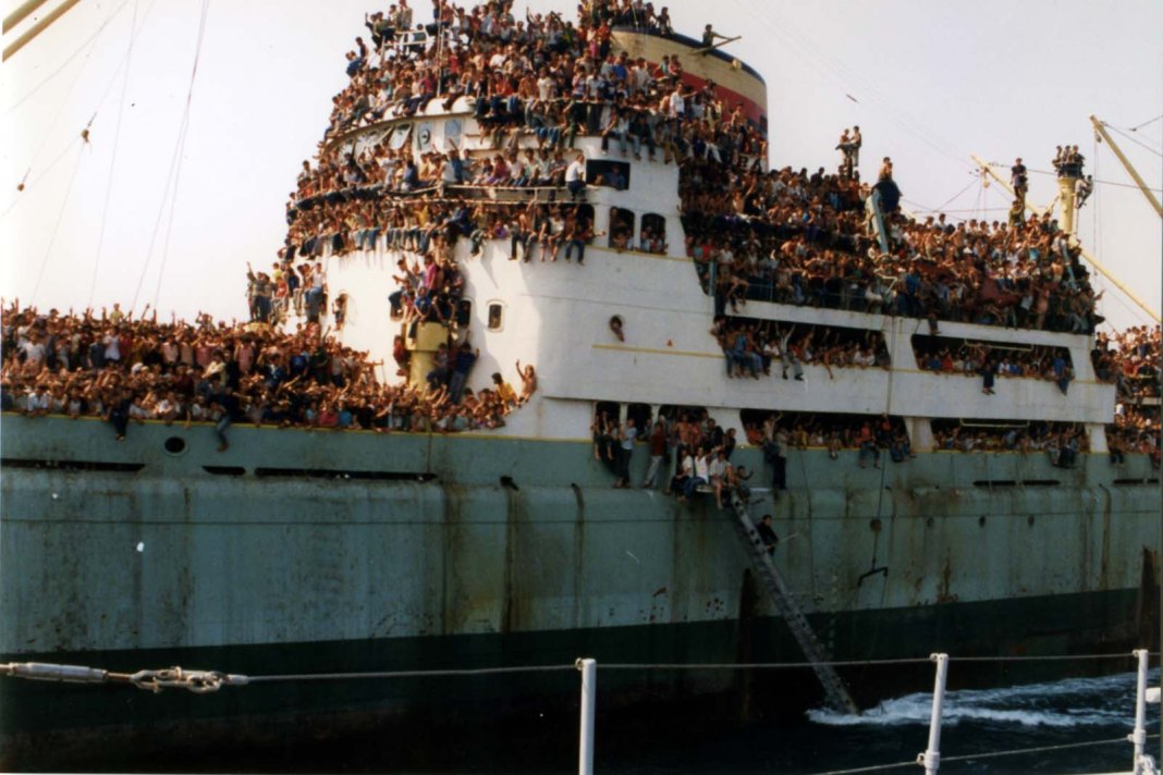 At 10 a.m. on Thursday 7 March 1991, the cargo ship 'Lirja' enters the port of Brindisi carrying 5,000 Albanians fleeing their homeland. They'd taken over the ship in the port of Durrës & forced the crew to sail to Italy. At noon, another ship 'Tirana' arrives carrying 6,000 >> 2
