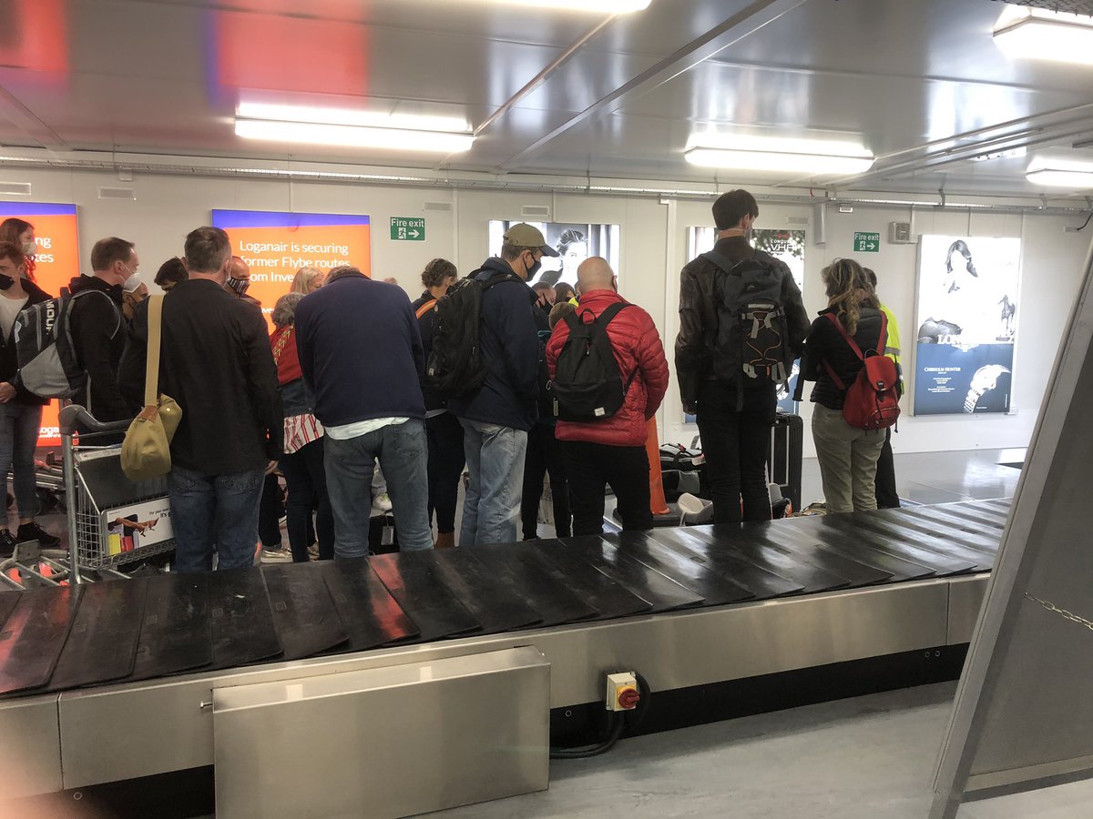 stuartabr's tweet photo. Shambolic experience. Herding passengers together to@collect luggage without any attention to social distancing in spite of signs everywhere. What a terrible example. #invernessairport https://t.co/yQYLRTSjqf