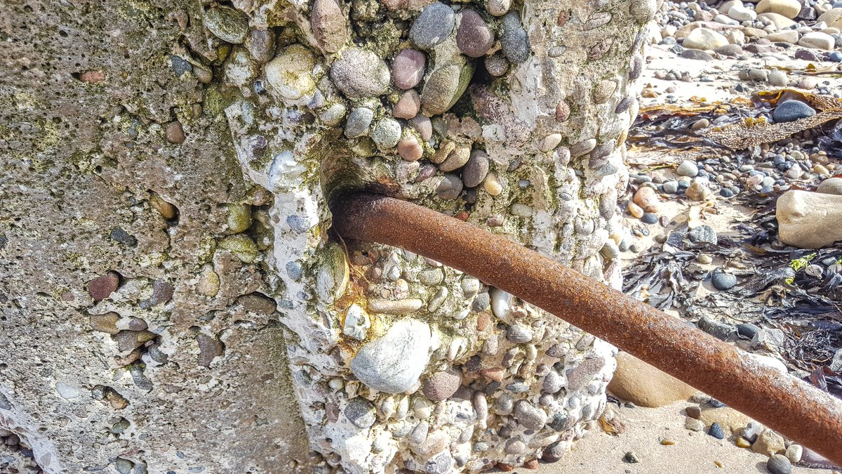 Not sure what the hollow pipe running through the base of the blocks is for. This would've been beneath the sand. Perhaps a cable run?