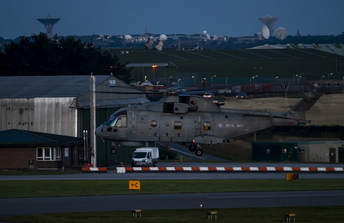 RNASCuldrose's tweet photo. One of our submarine-hunting Merlin MK2 helicopter crews off to hone their night flying skills last week. That’s @goonhillyorg in the background. #SchoolOfMerlin https://t.co/v1nSBwiBn3