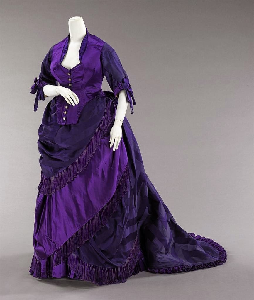 AFTERNOON DRESS: they were usually lavishly trimmed, with low necklines. The sumptuous fabric was typically used and often with a train. Ladies would dress-up in these either for visiting friends or for receiving friends at home.