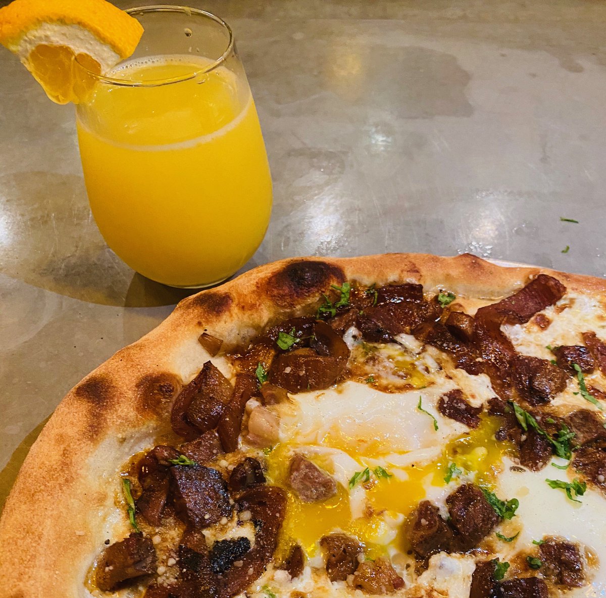Steak N Eggs! Happy Brunch Day, you survived another week. Time to celebrate with our brunch pie &amp; mimosa! Our POTD has Steak, Caramelized Onions, Fontina &amp; Eggs. Happy Brunching !