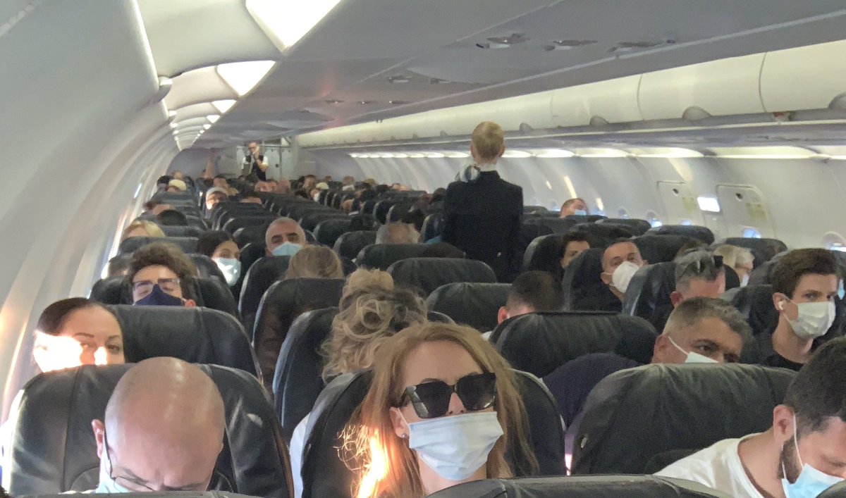 1st photo is taken on the stairs leading up to the aircraft - “Keep safe 1.5m distance” OUTSIDE. INSIDE fully packed aircraft of BulgariaAir not even one free seat! How am I supposed to keep a safe 1.5m distance if I’m in the middle seat between two big guys on both my sides? 🤬