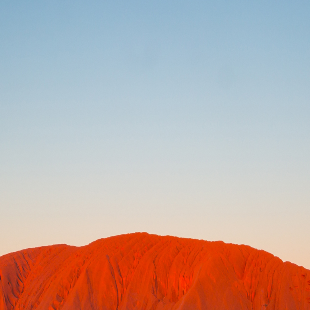 It looks like Ayers Rock has a halo, right?  But it's the sunset against the rock.  Truly stunning!  Don't you think?  #God #nature #trekforjoy #ayersrock #australia #theoutback