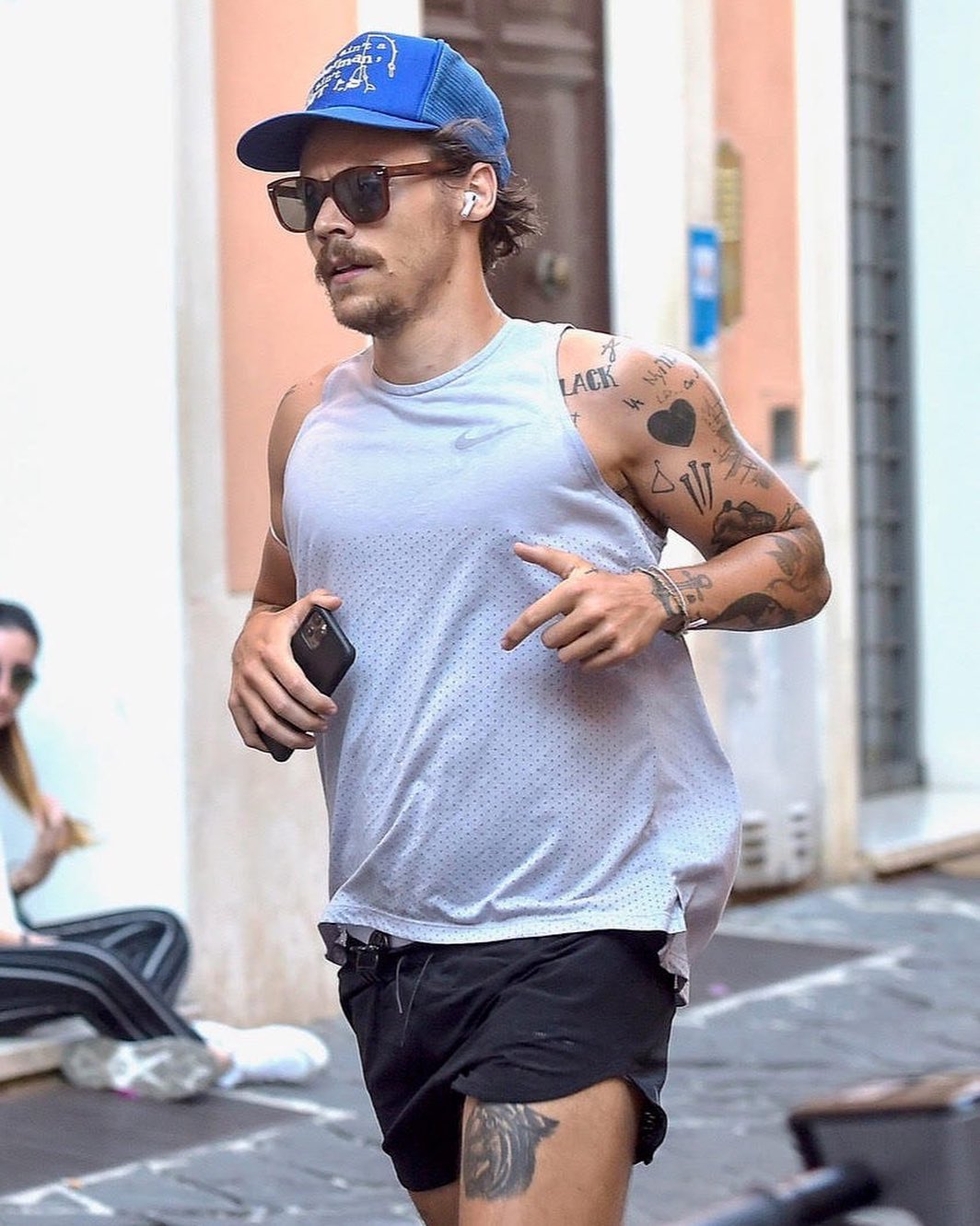 GQ Magazine on X: .@Harry_Styles sports all the running essentials: trucker  cap, mustache, airpods, short shorts.  / X