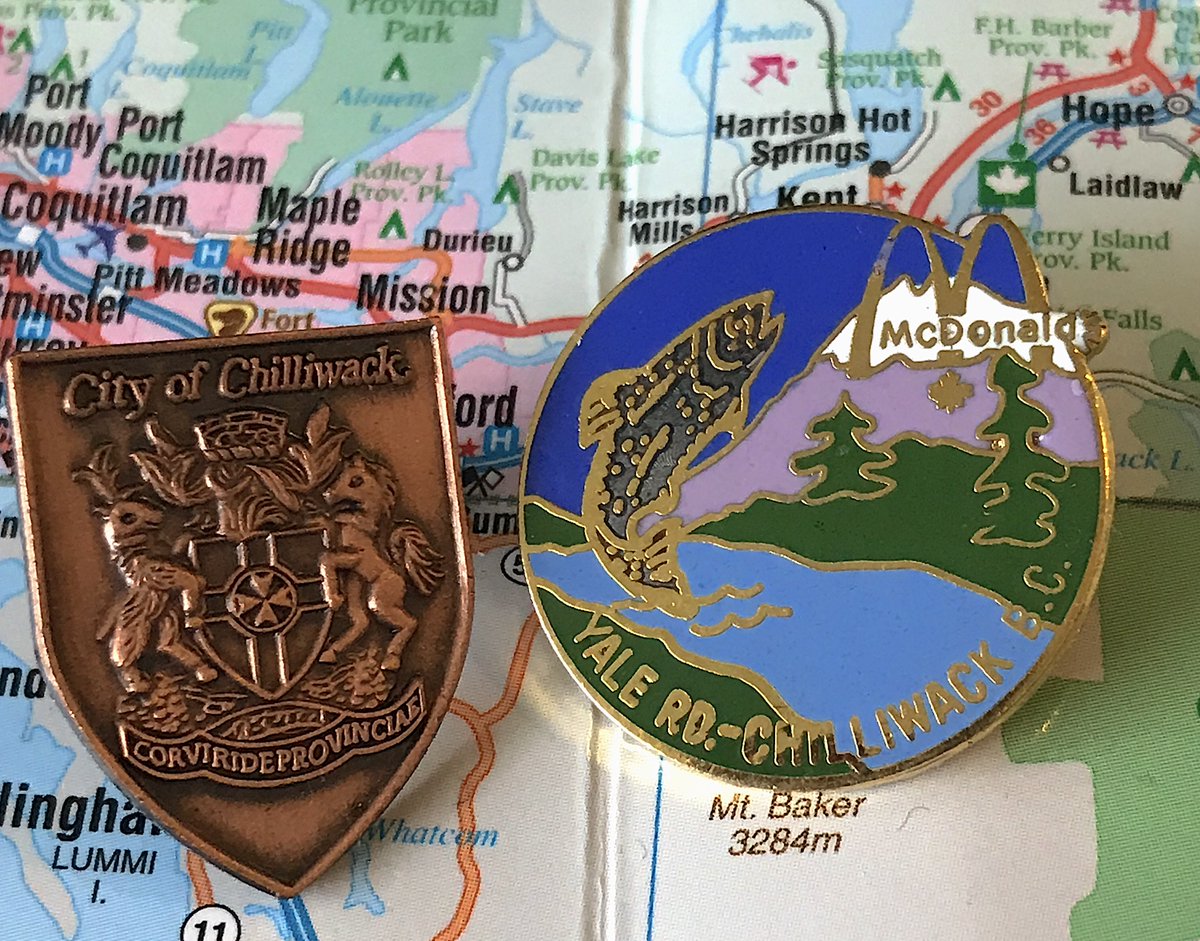 71. CHILLIWACK - We're using the McDonald's pin on the right because it's amazing and the official pin is boring- The salmon is 40 feet tall and will destroy us all- The trees are drawn by children? I think? - Yes, McDonald's made pins for specific B.C. stores, very normal