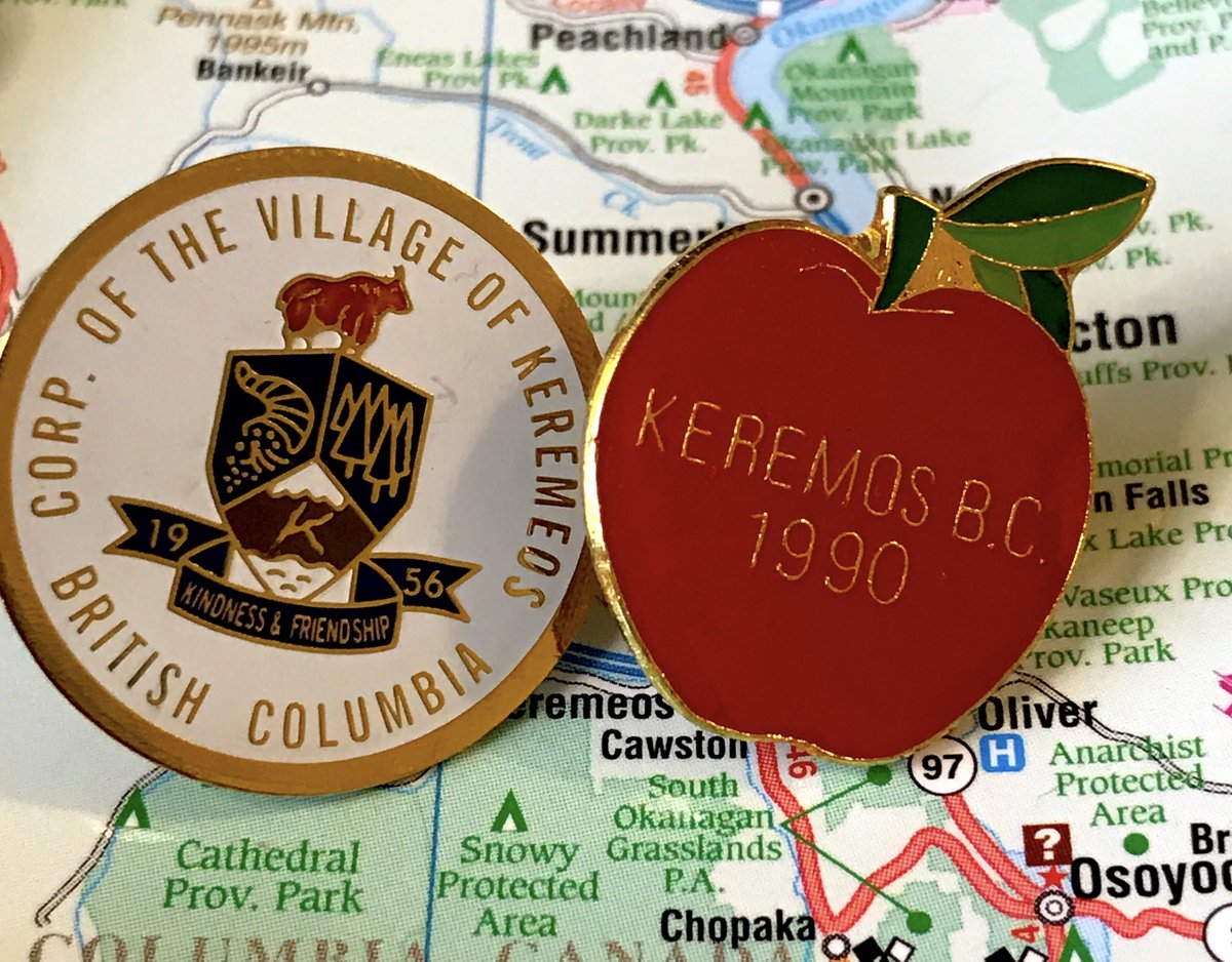 68. KEREMEOS- The spelling mistake on the apple is hilarious- Also Keremeos incorporated in 1956, what happened in 1990- Cute and on brand though- Modern corporate pin is not bad, "Kindness and Friendship" makes me smile