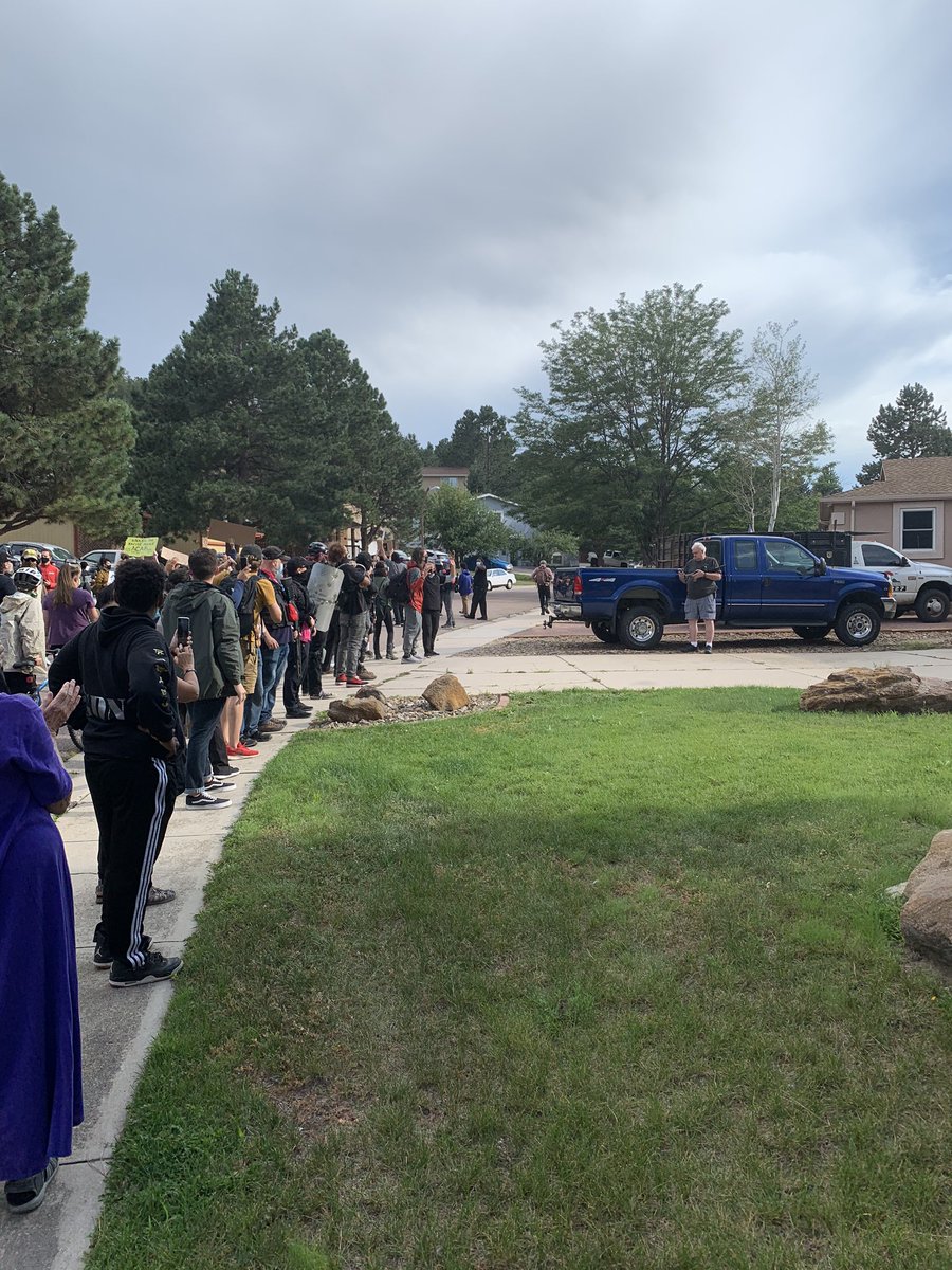 Crowd is in front of Truck guy #2’s house, and he grabbed his gun.