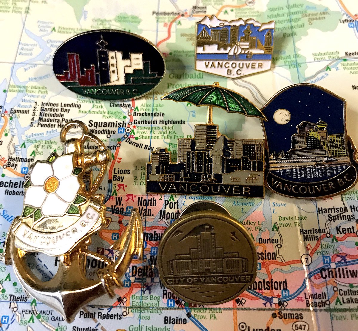 17. VANCOUVER - There are many Vancouver pins; most are quite good - None 100% excite me but maybe that's because I live here- Love how cool and 80s the first one is, delighted by the umbrella in the second- We need more pins with Science World instead of Harbour Centre