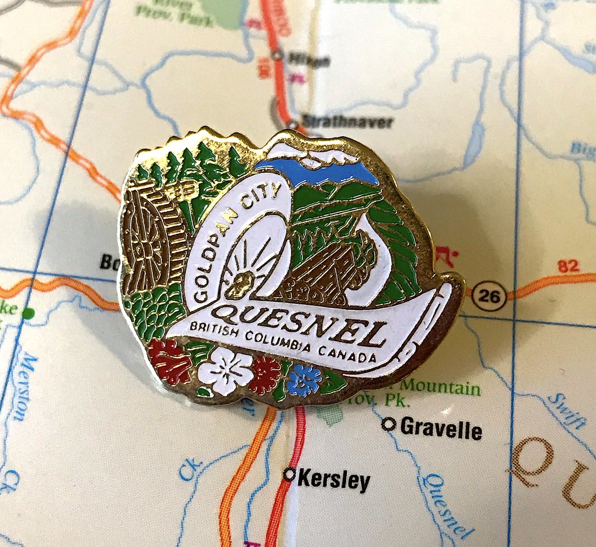 13. QUESNEL- Oh wow just a lot happening, most of it good!- Is that a truck taking trees away?- Really good of how pins work better in B.C. than flags if a town hires someone to make one logo, because they can bend to a unique shape instead of fitting in a rectangle