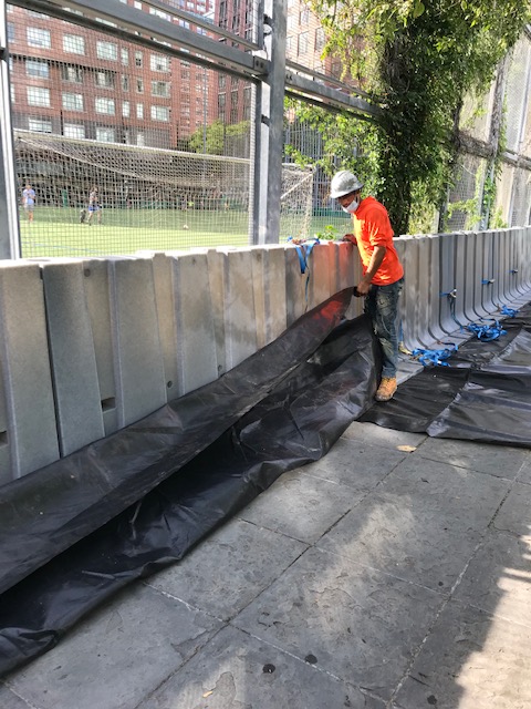 bpca_ny's tweet photo. THE GATHERING STORM: As a precautionary measure as #HurricaneIsaias approaches, we installed temporary flood barriers today around the #BPC Ball Fields. For latest forecast track of the storm: https://t.co/T4GqWUrM6O #BPCCommunity #BPCResiliency @CommunityBoard1 @TribecaTrib https://t.co/fJH3pPtjiW