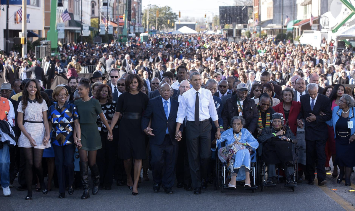 A photo of President Obama walking in Selma, Alabama with his family, John Lewis, and hundreds of other people on the 50th anniversary of Bloody Sunday in 2015.