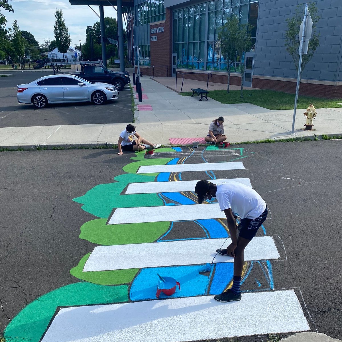 LottaFish's tweet photo. School #outdoors?  LOF rehabilitates school crosswalks w/ colorful graphics. Youth are employed to paint crosswalks, storm drains, and rain barrels.  5-week program produced artworks that beautify public space &amp; educate the public about #water pollution. #H2Oed #RunoffArt #art https://t.co/IzwzNQezGu