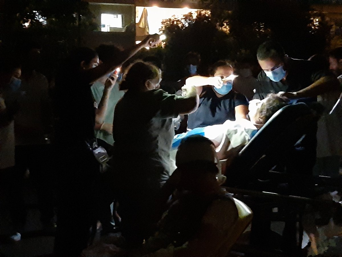 sewella's tweet photo. Hospitals overwhelmed after Beirut explosion. In Geitawi, medical staff treating patients in a parking lot. https://t.co/xwC3eBn49r