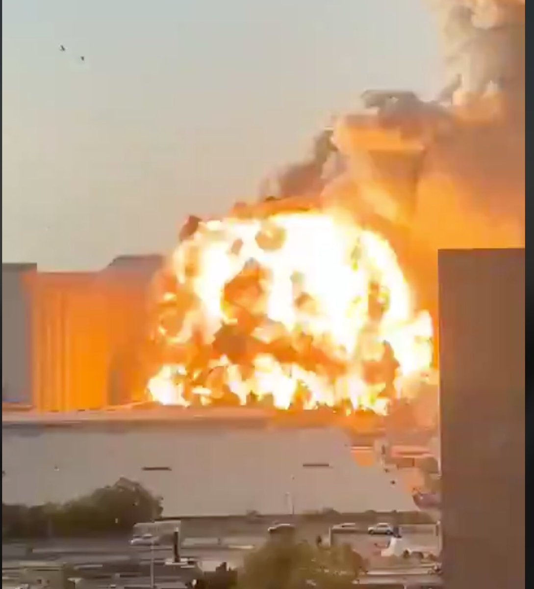 looking at some other angles it is clear that the silos were destroyed by the explosion and the origin is the warehouse looking thing in front of itthere’s also some weird shit in the air shortly before the explosion