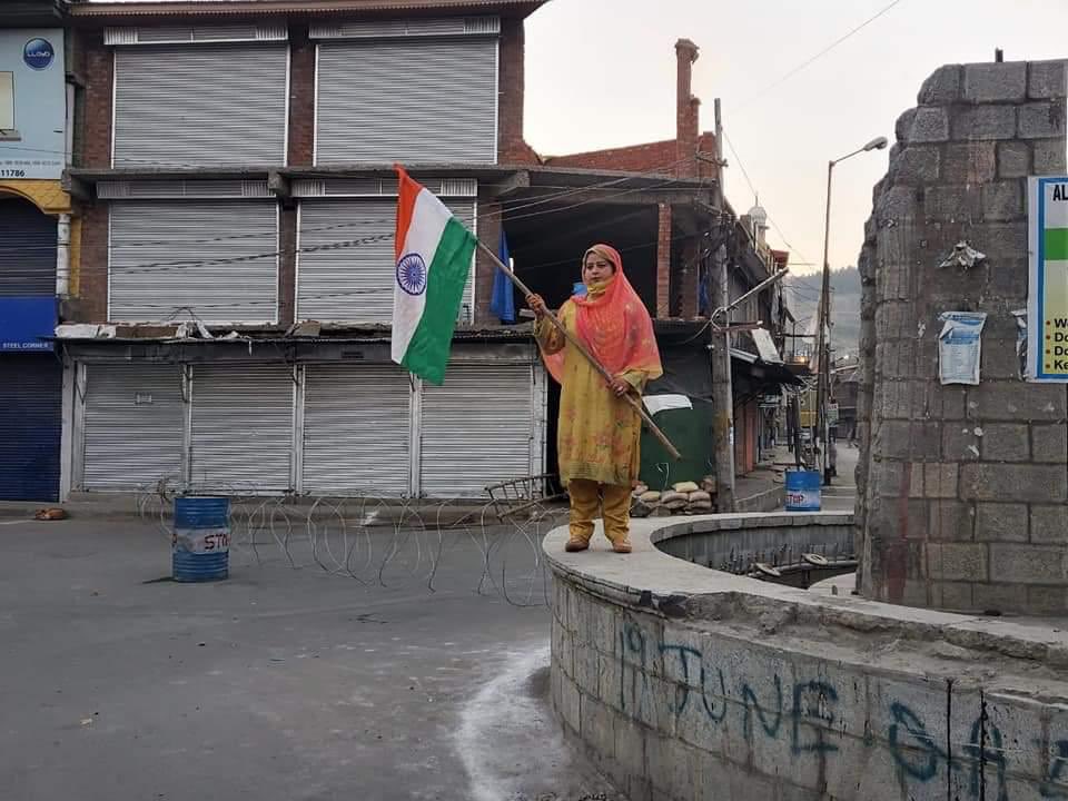 Local BJP Leader Rumisa Rafiq hoists and salutes the Indian tricolour at Lal Chowk in South Kashmir's Anantnag district on the 1st anniversary of Article 370 and 35A abrogation from J&K inspite of repeated threats of Pakistani terrorists and radical separatists.