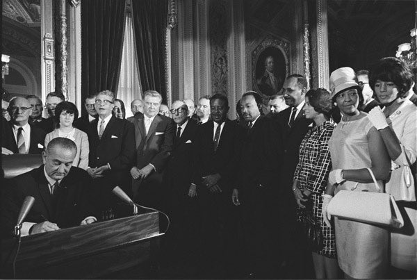 This photo is among my favorites. Here, is the signing ceremony for the Voting Rights Act in 1865. You likely recognize many of the men: Lyndon Johnson, Ralph Abernathy, Martin King. The last man on the right is Clarence Mitchell, the NAACP’s lobbyist.