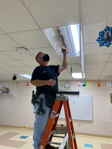 pvdschools's tweet photo. Bright spaces for bright minds! Our facility teams are going through each school building to replace or repair light fixtures in classrooms, like this bulb replacement work at @CarnevaleES. #PPSDfall2020 https://t.co/ny1twBibcJ