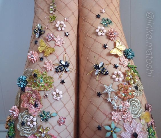 the designer of this dress is Lirika Matoshi. she is a 20-year-old kosovo native, based in new york city. before getting popular and making herself a name, she was actually selling her creations (hand embellished dresses, tights, socks, blouses..) on etsy!