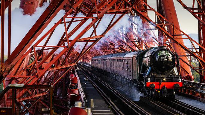 GREATBritain's tweet image. Two engineering masterpieces meet! The Flying Scotsman crossing the Forth Bridge is always a magical moment. #EngineeringIsGREAT 🚂