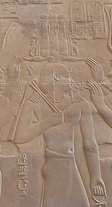 The Hemhem, during Akhenaten replaced the Atef. It was formed from reeds and ostrich feathers topped by sun disks set on top of a pair of long spiral ram’s horns with a cobra on either side of the crown. Hemhem means to shout or cry out, it may have represented a battle horn.