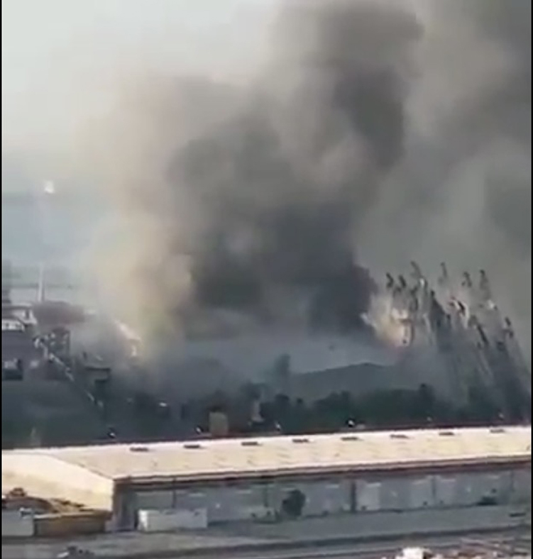 Those are DOCK CRANES on the right.My guess is the Iranians and Hezbollah planned to remove the missiles and rocket fuel by crane.They kept the firefighters out.