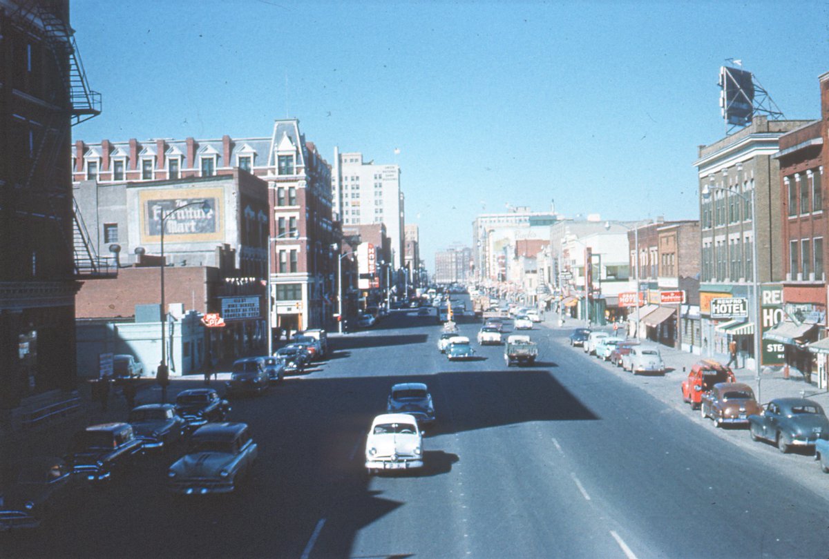 We love mid-century downtown. Looking west on East Douglas, 1955. Victory Theatre marquee, east of the Eaton Hotel, is at left, Renfro at right. #photo from our #archive #cars  #ThrowbackThursday <a href="/DowntownWichita/">Downtown Wichita</a> <a href="/CityofWichita/">City of Wichita</a> <a href="/VisitWichita/">Visit Wichita</a> #SupportLocalMuseums #ICT150