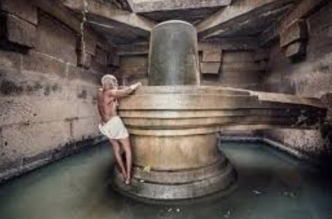 Shri K N Krishna Bhat, around 86 yr old, who has been the priest at the Badavi Linga temple in the world famous Hampi heritage site for decades, With the three-metre tall monolithic lingam, he has no option but to cling to the structure while clearing it as a daily ritual.