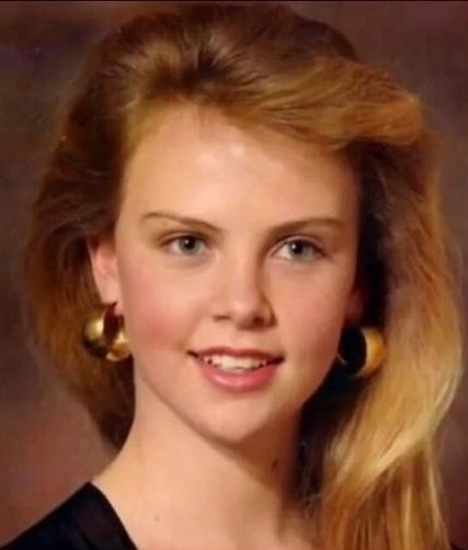 Theron creció en una granja cerca de Benoni, Sudáfrica.Es de ascendencia afrikaner (holandesa, con franceses hugonotes y alemanes).Su tío-abuelo, Danie Theron, fue una figura militar afrikaner.A los 13 años, queriendo continuar sus estudios de ballet, comenzó a asistir a