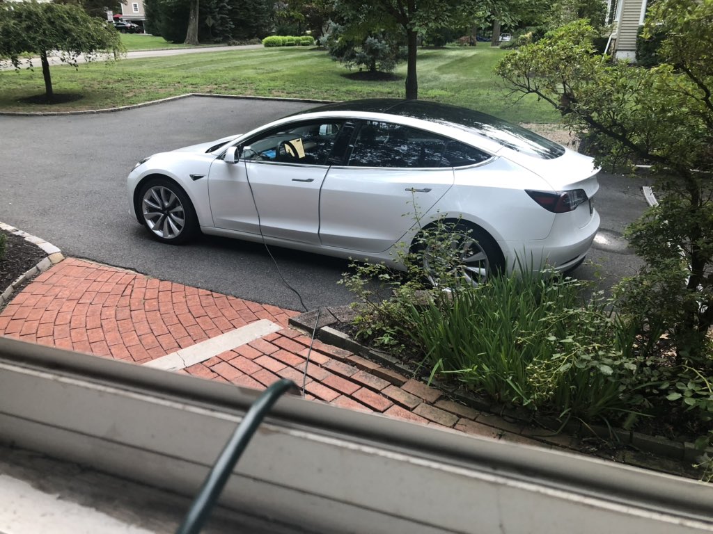 JohnLHanson's tweet photo. Day 3 of no electricity in NJ, but still hard at #workfromhome thanks to @Tesla Model 3, an extension chord, and @elonmusk. #isaias #poweredbyTesla https://t.co/cXJhXF2y93